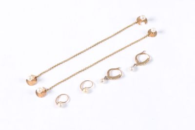 three pairs of earrings and a chain on a white surface