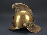 an antique brass helmet on a black background with a gray background