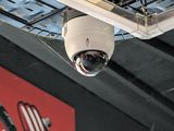 a surveillance camera hanging from the ceiling of a building