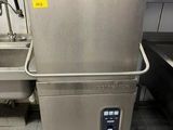 a stainless steel dishwasher sitting in a kitchen next to a sink