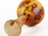 an image of a glass vase with a leaf design on it
