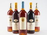 three bottles of wine sitting next to each other on a white surface