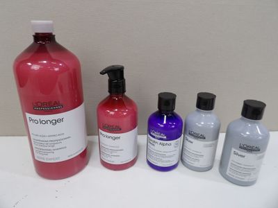 four bottles of shampooe and a bottle of conditioner