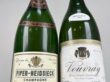 two bottles of wine sitting next to each other on a table
