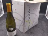 a bottle of wine sitting next to a box of wine