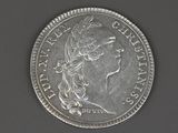 a close up of a silver coin with a woman ' s head on it