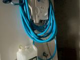 a blue hose attached to a wall mounted shower head