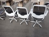 several office chairs and desks in a room with tables and chairs