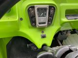 a close up view of a dashboard of a green car