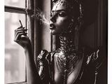 black and white photograph of a woman smoking a cigarette in front of a window