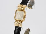 a close up of a wrist watch with a black band