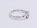 silver ring with a single diamond on a white background