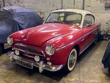 a red and white car parked in a garage