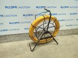 a yellow hose sitting on a stand in front of a wall
