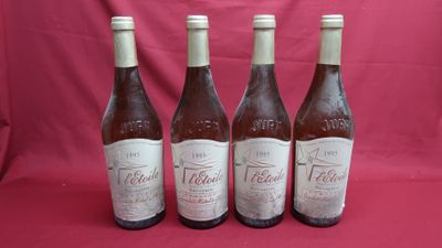 four bottles of wine are lined up on a red background