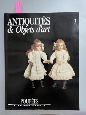 an antique book with two dolls in it on a table