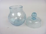 a glass jar with a lid and a glass jar with a lid on a table