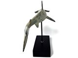 a sculpture of a shark on a black stand