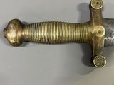 an image of a sword that is sitting on top of a table