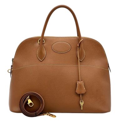 a brown leather handbag with a key on the handle