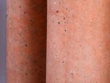 two large red clay vases sitting next to each other on top of a table