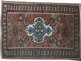un vieux tapis orné d'un motif bleu et marron sur fond blanc