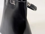 black leather handbag with metal handles on a white background