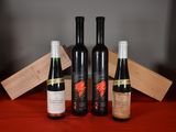 three bottles of wine sit on a table next to a wooden box