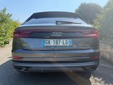 the rear end of an audi qx parked in a parking lot
