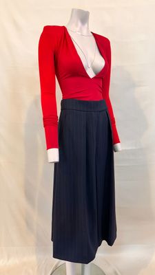 a mannequin with a red top and black skirt