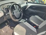 the interior of a small car with a steering wheel and a dashboard