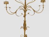 an antique brass candelabra with five candles on a stand
