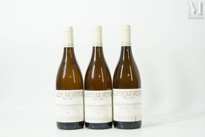 three bottles of wine sitting next to each other on a white surface