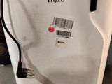 a white refrigerator with a black handle and a barcode on it