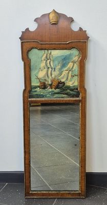 un miroir sur lequel est représenté un bateau