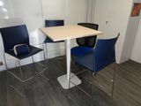 two chairs and a table in the corner of a room