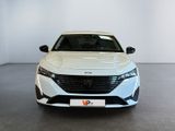 the front view of a white car parked in a showroom