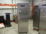 two refrigerators that are in a room with a lot of shelves