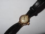 a watch that is sitting on a white surface