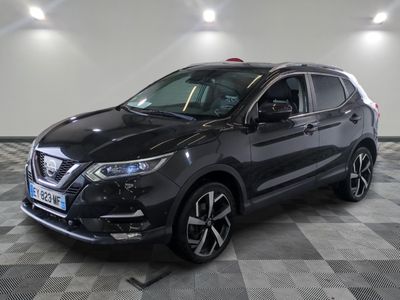 a black nissan suv parked on a checkered floor in a garage