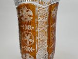 a glass vase with a floral design on it