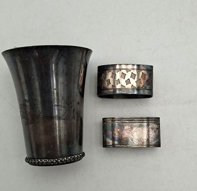 un vase en argent et deux serviettes en argent posés sur une table