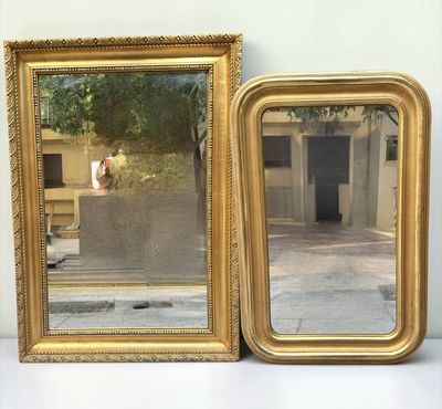 two mirrors sitting next to each other on a table