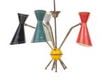 four different colored lamps hanging from the ceiling