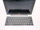 a white laptop with a black keyboard on a white table