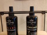 two bottles of shampooe sitting on top of a shelf