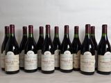 several bottles of wine are lined up on a table