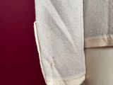a close up of a mannequin torso with a white sweater on it