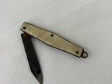 a small knife that is laying on a white surface