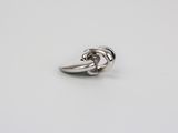 a close up of a silver ring on a white surface